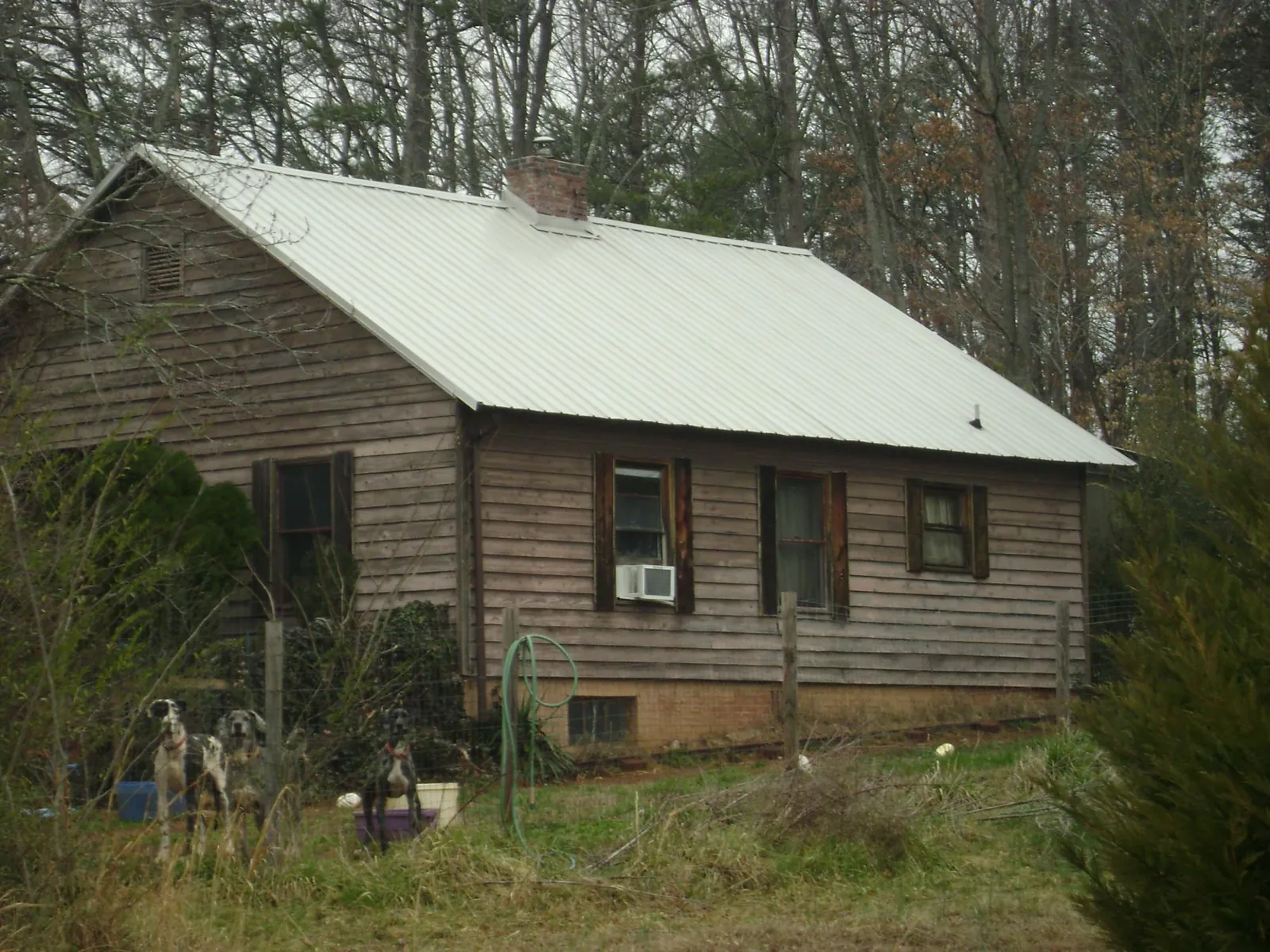 White metal roof on an old wood sided farmhouse, from a Metal Roof Installation job in Drexel